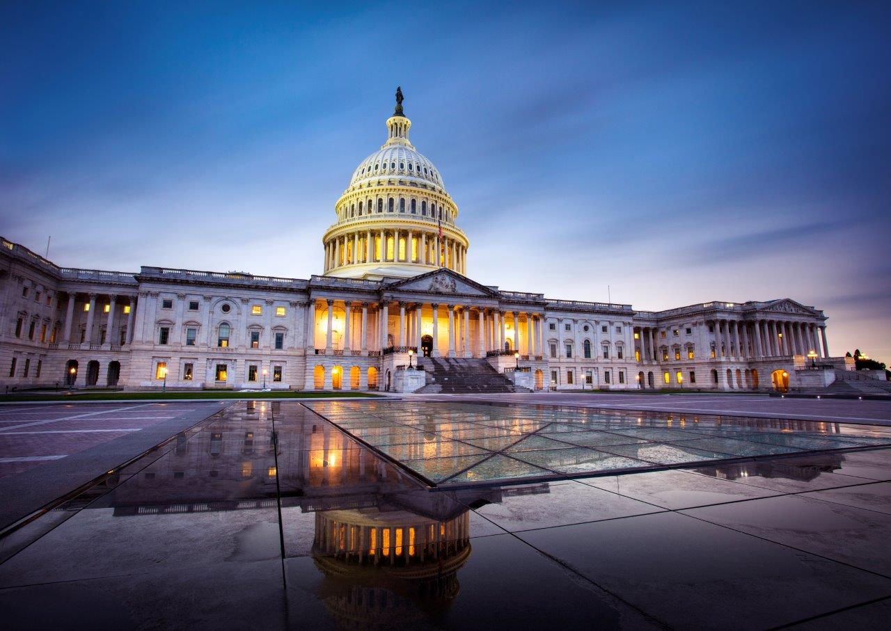 ALT Text: an Image of the Capital building with the Sun set in the background